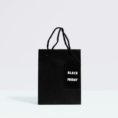 Black Friday shopping bag displayed on a minimalist background, perfect for sale promotions.